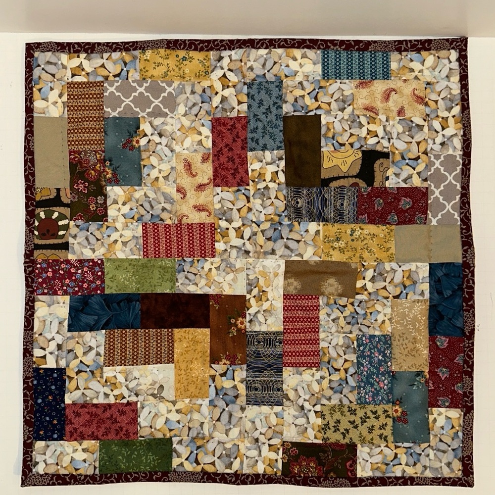 A handmade 19” x 19” Square Mini Quilt with Multicolor Design